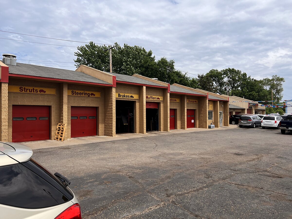 AutoMax's labeled service bays — struts, steering, brakes and mufflers — on University Ave in Saint Paul