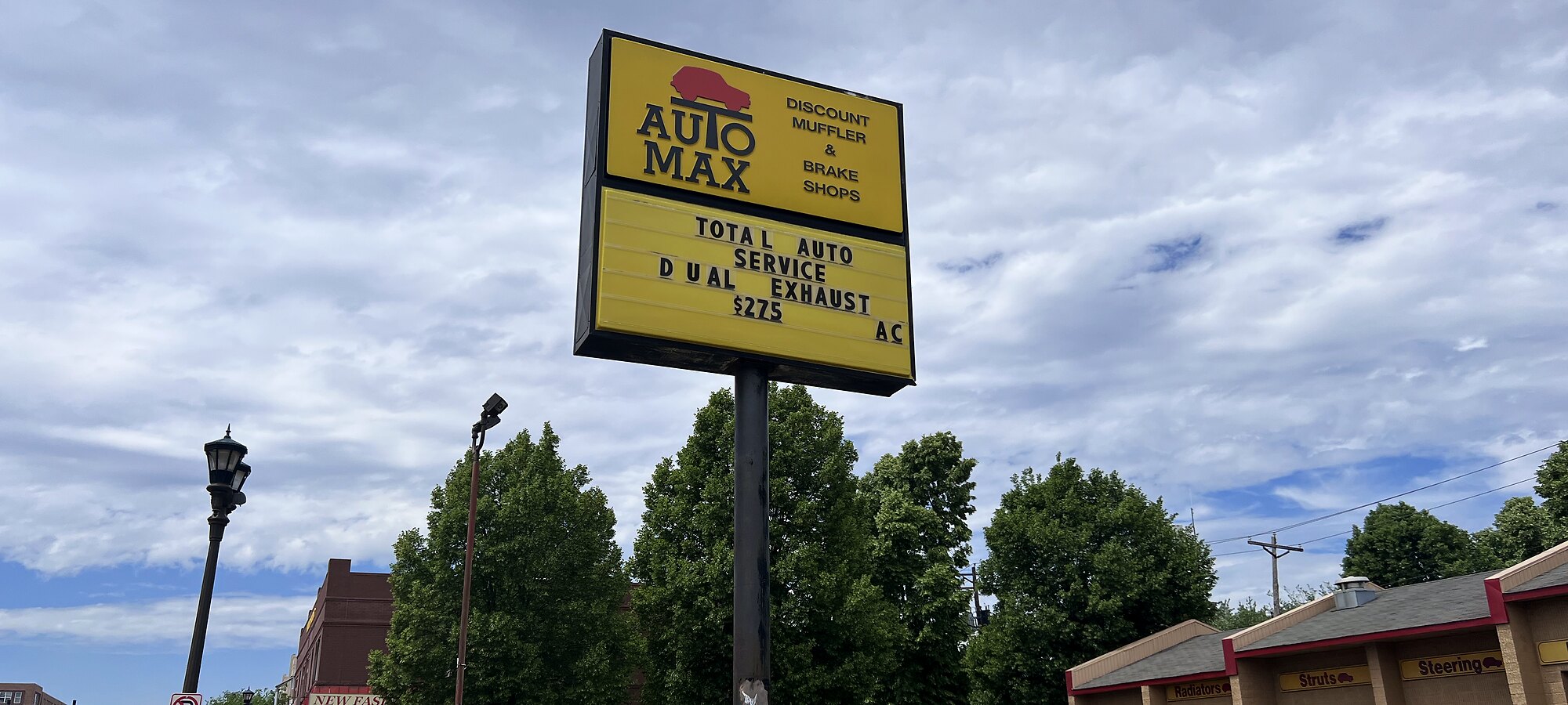 The tall yellow AutoMax sign on University Ave W in Saint Paul — Total Auto Service, Dual Exhaust